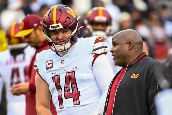 Washington Commanders quarterback Sam Howell (14) talks with Washington Commanders offensive coordinator Eric Bieniemy before the game against the Dallas Cowboys at FedExField. Mandatory Credit: Brad Mills-USA TODAY Sports